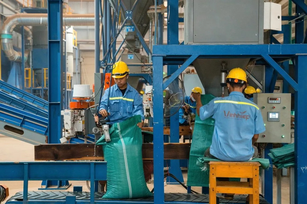 Employees operating factory equipment