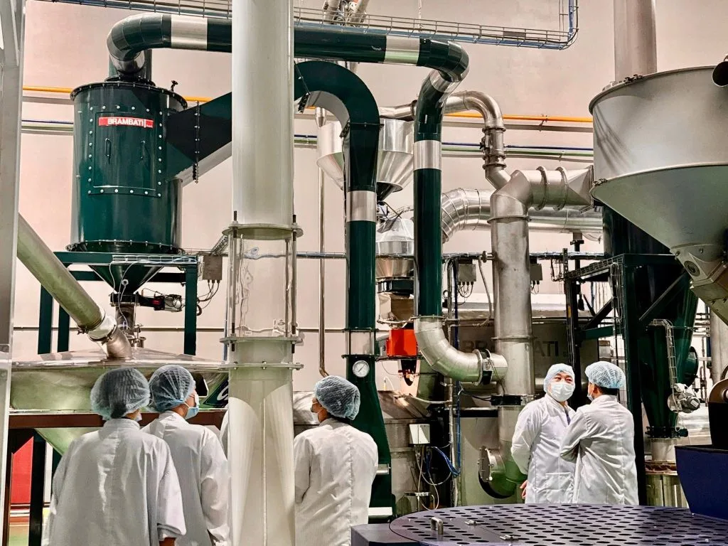 The delegation visits processing equipment at L’amant Café's Gia Lai factory.